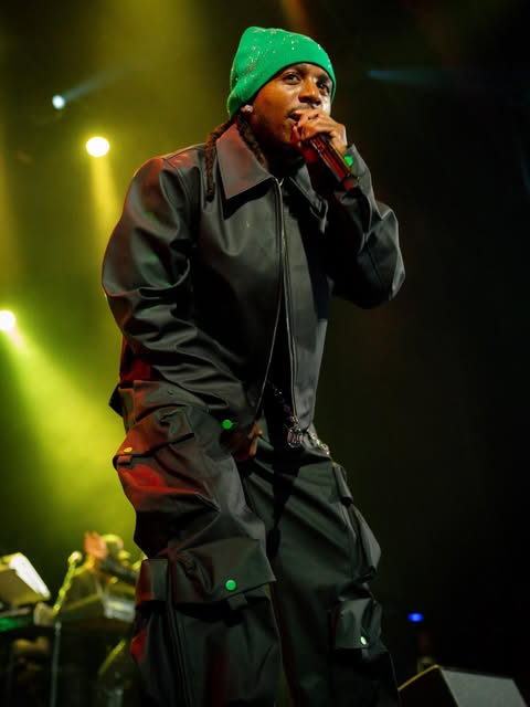 Artist performing on stage in HHUE leather